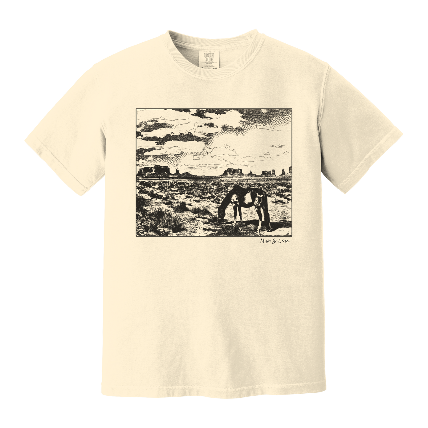 Desert Horse t-shirt in Ivory (cream), with a lone horse grazing before desert buttes under a softly clouded southwestern sky.