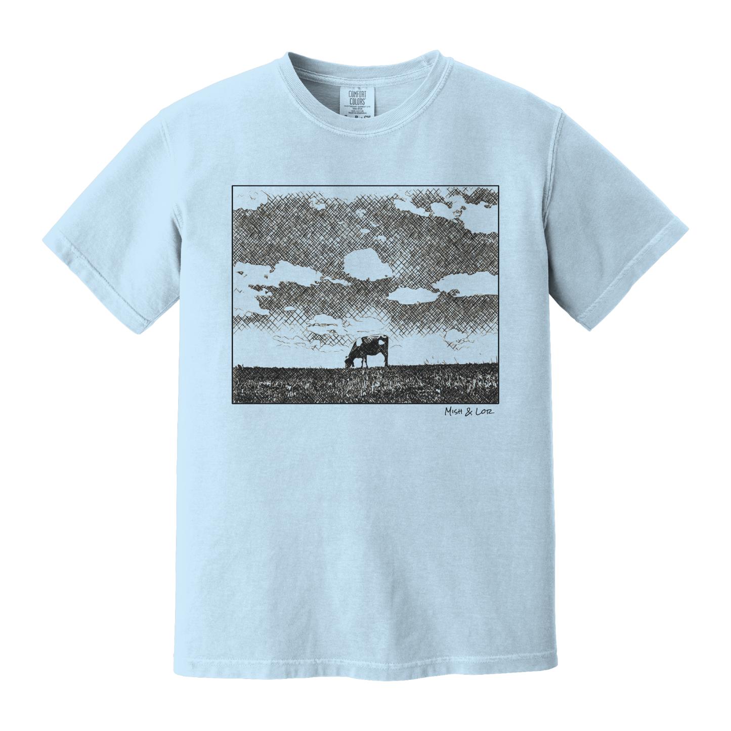 Front view of the Field Cow Cotton T-Shirt in Chambray (baby blue) featuring a whimsical black-and-white rendering of a lone cow grazing in a field beneath a cloud-dotted sky