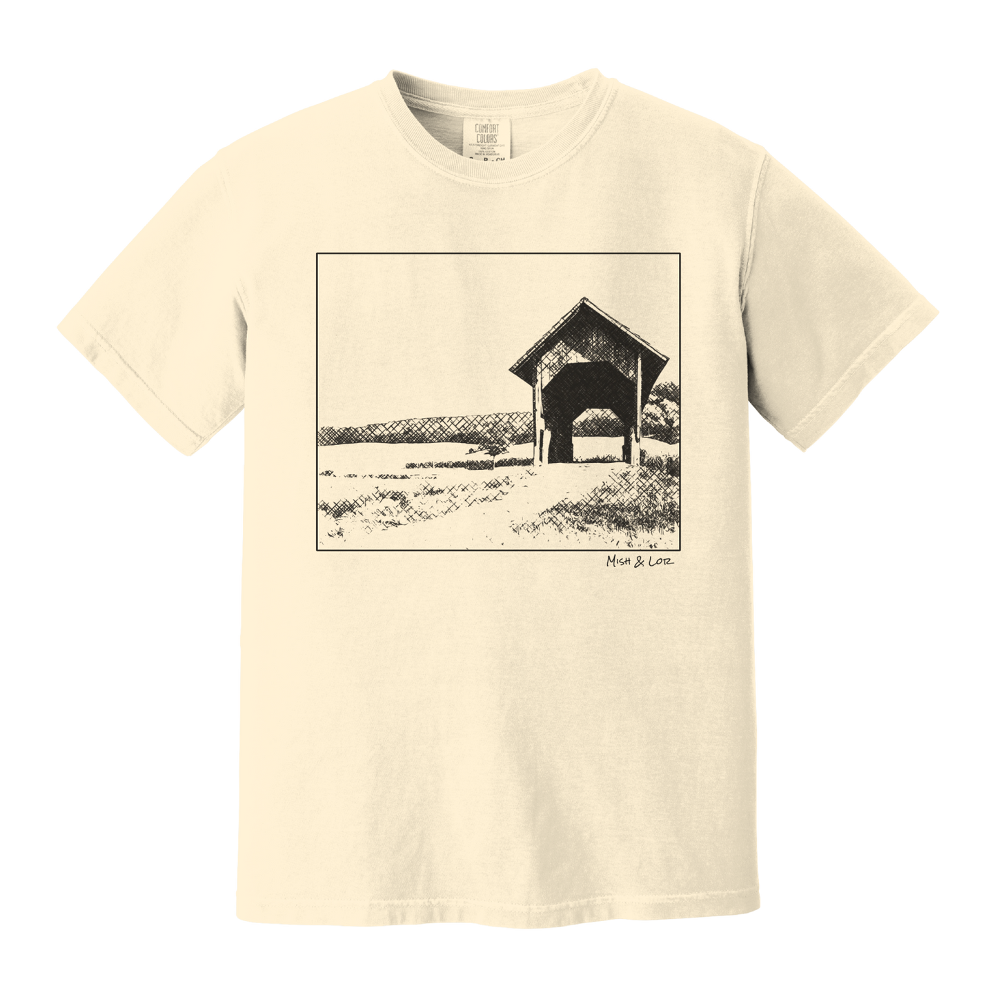 Front view of the Covered Bridge cotton t‑shirt in Ivory (cream), with a storybook scene of a rustic covered bridge arching over a quiet Vermont dirt road.