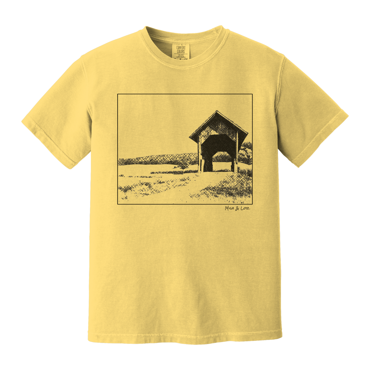 Front view of the Covered Bridge cotton t‑shirt in Mustard (yellow), with a storybook scene of a rustic covered bridge arching over a quiet Vermont dirt road.