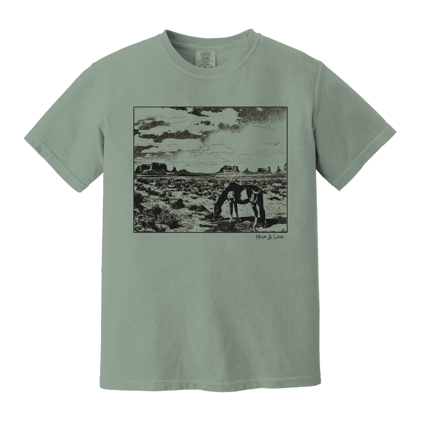 Desert Horse t-shirt in Bay (green), with a lone horse grazing before desert buttes under a softly clouded southwestern sky.