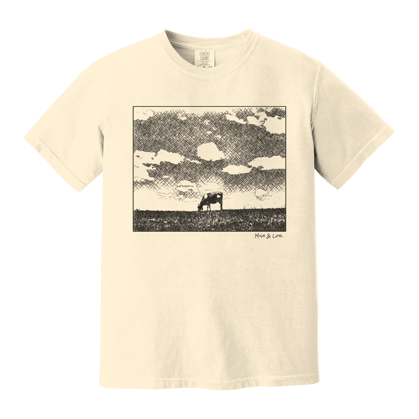 Front view of the Field Cow Cotton T-Shirt in Ivory (cream) featuring  a whimsical black-and-white rendering of a lone cow grazing in a field beneath a cloud-dotted sky