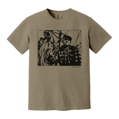 Front view of the Fisherman Cotton T-Shirt in Khaki (beige), featuring a vintage portrait of a fisherman in flannel, gripping ropes on a boat with a cigar in his mouth.