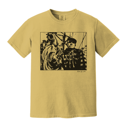 Front view of the Fisherman Cotton T-Shirt in Mustard (yellow), featuring a vintage portrait of a fisherman in flannel, gripping ropes on a boat with a cigar in his mouth.